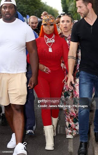 Person in red jumpsuit and white boots