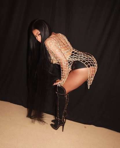 Woman in beaded outfit and thigh-high boots