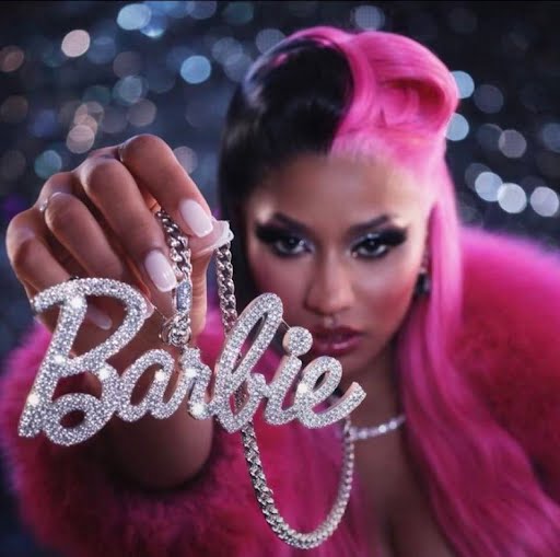 Person with pink hair holding sparkling "Barbie" necklace