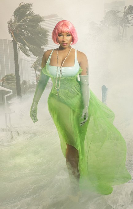Woman in pink wig and green flowing dress
