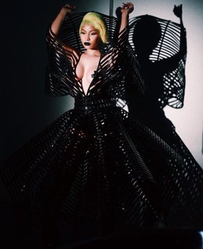 Person in dramatic black lattice gown with shadow